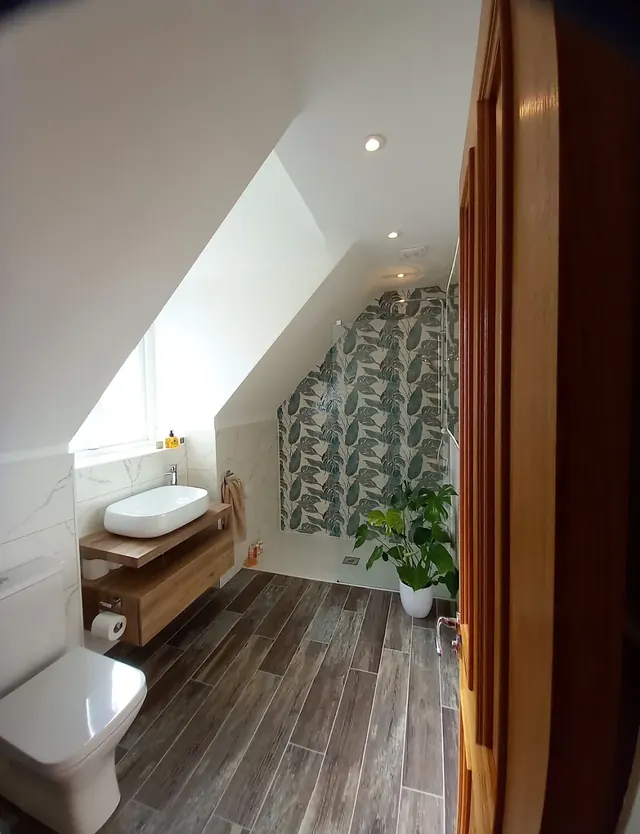 Loft shower room with a walk-in shower, a feature tiled wall and a countertop basin
