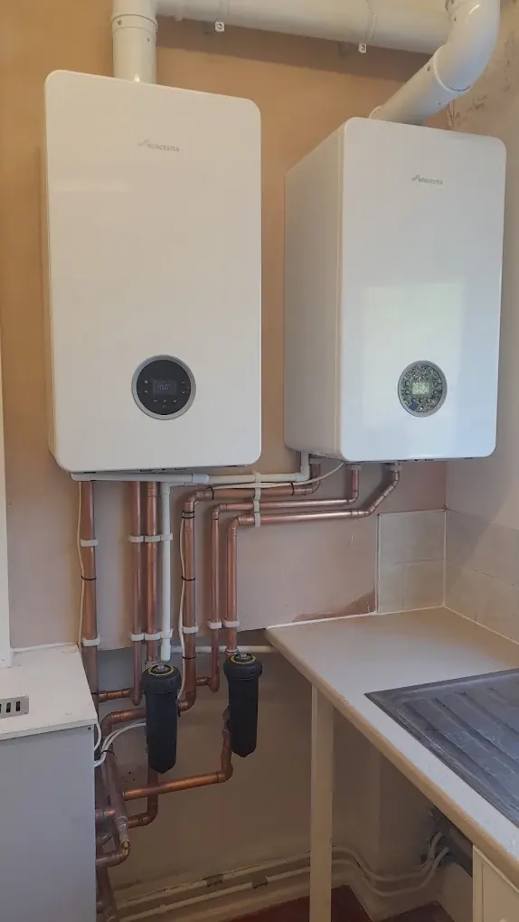 Two Worcester Bosch boilers fitted side by side, each with new copper pipework and its own magnetic filter