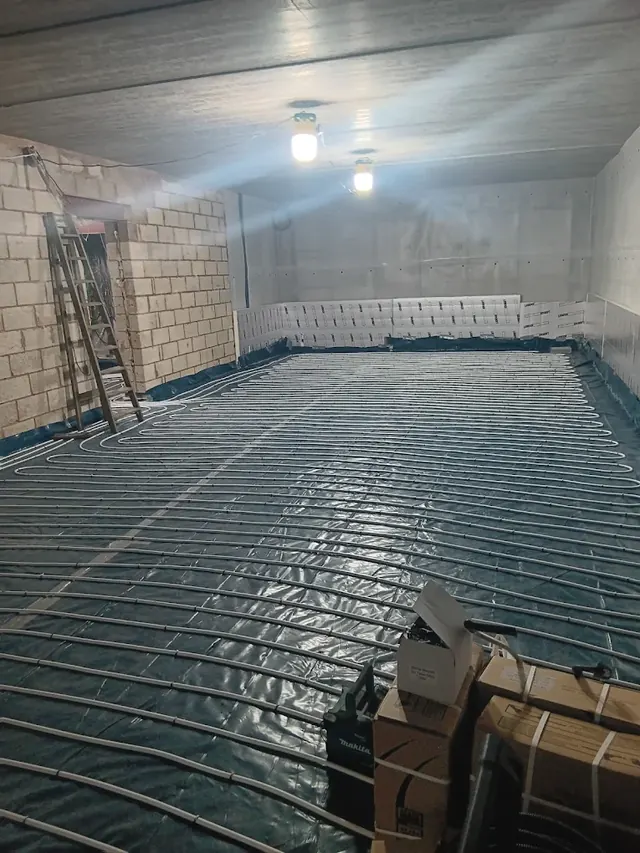 Underfloor heating pipe laid across a large new ground floor, ready for the screed