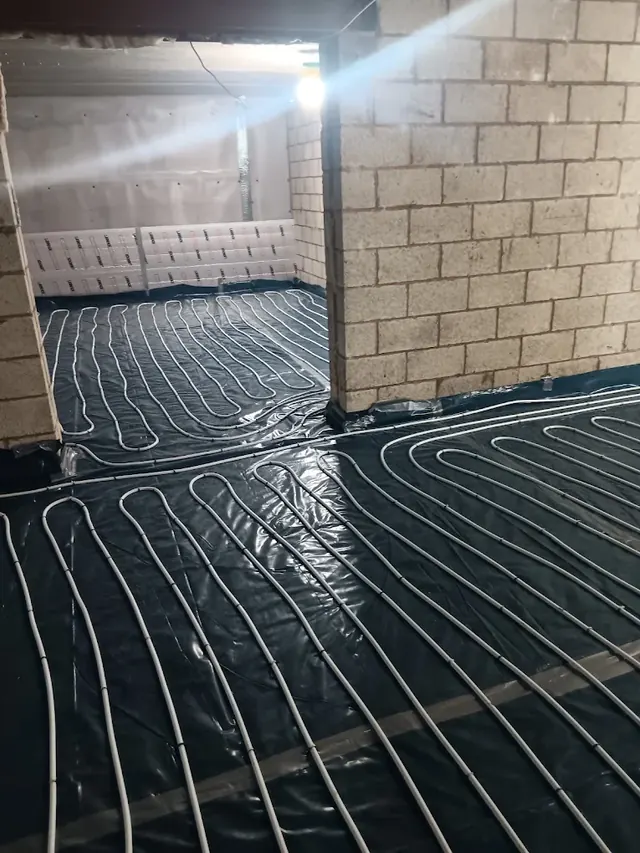 Underfloor heating loops running through two rooms of the same build