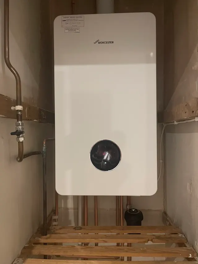 New Worcester Bosch boiler. The label on the front records the system being cleaned and protected at handover in February 2026
